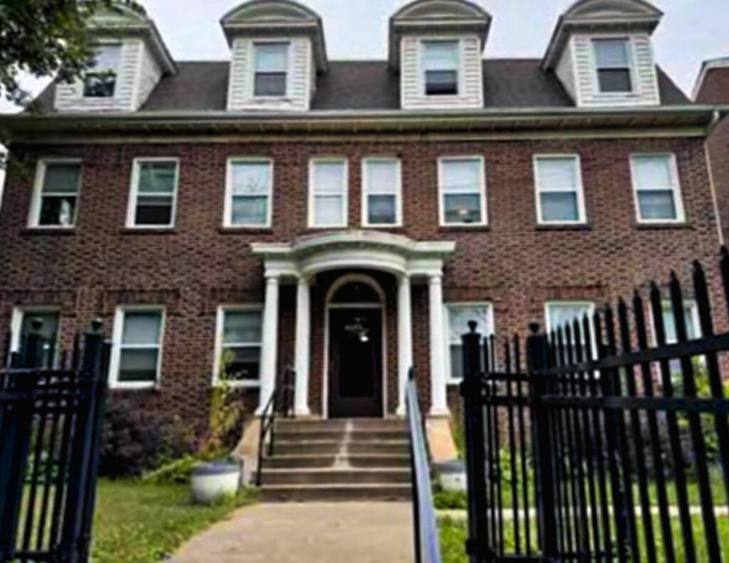 6-plex apartment building that is brick with dormers.